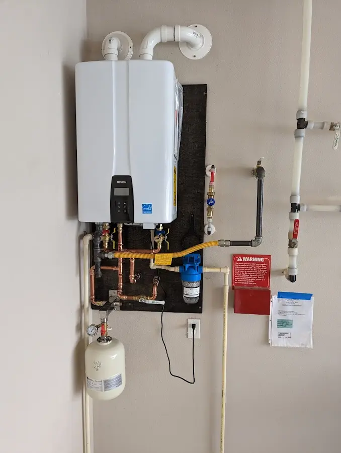 Professional plumber installing copper piping in a Stonington home